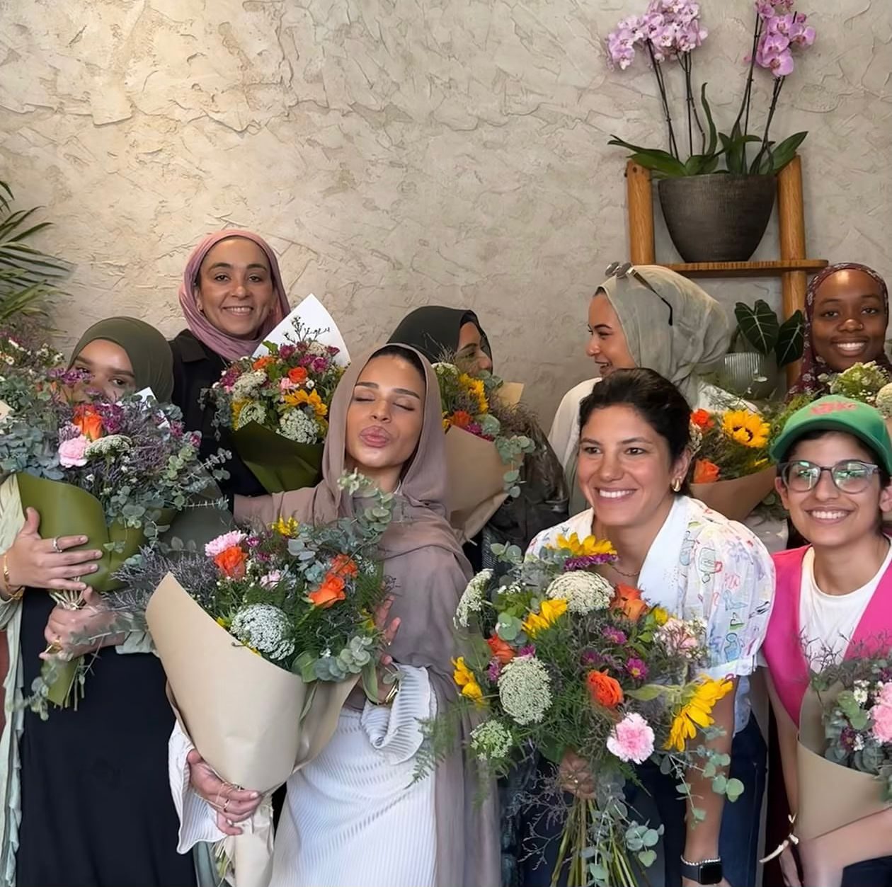 GND Club members holding fresh flower bouquets after a workshop